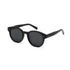 Reese - Polished Black round sunglasses by KayTran Eyewear, dark lenses, angled right on a white background.