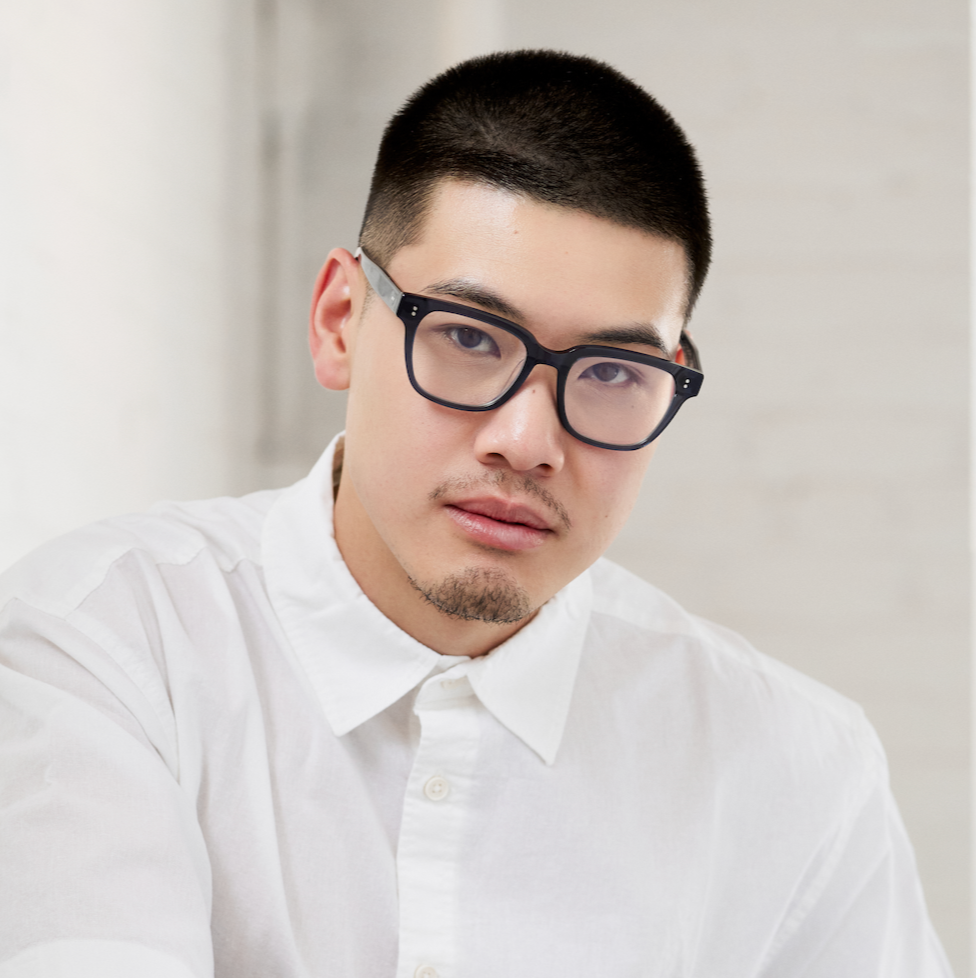Man with short hair wears KayTran Eyewears Charlie Optical - Polished Black, looking at camera against neutral background.