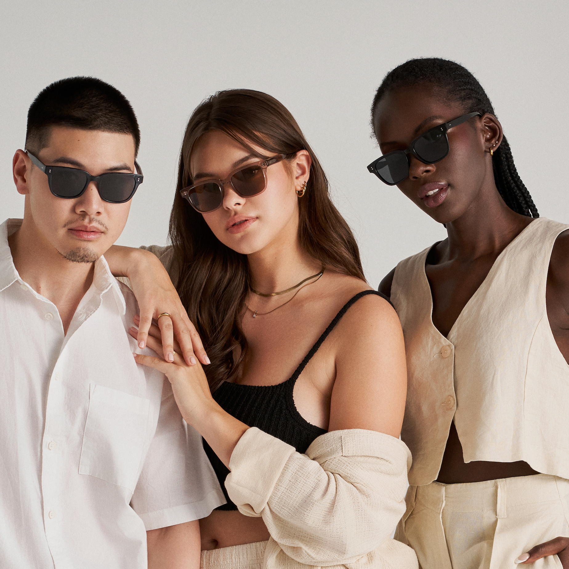 Three people pose in KayTran Eyewear’s Charlie - Polished Black sunglasses against a plain light background.
