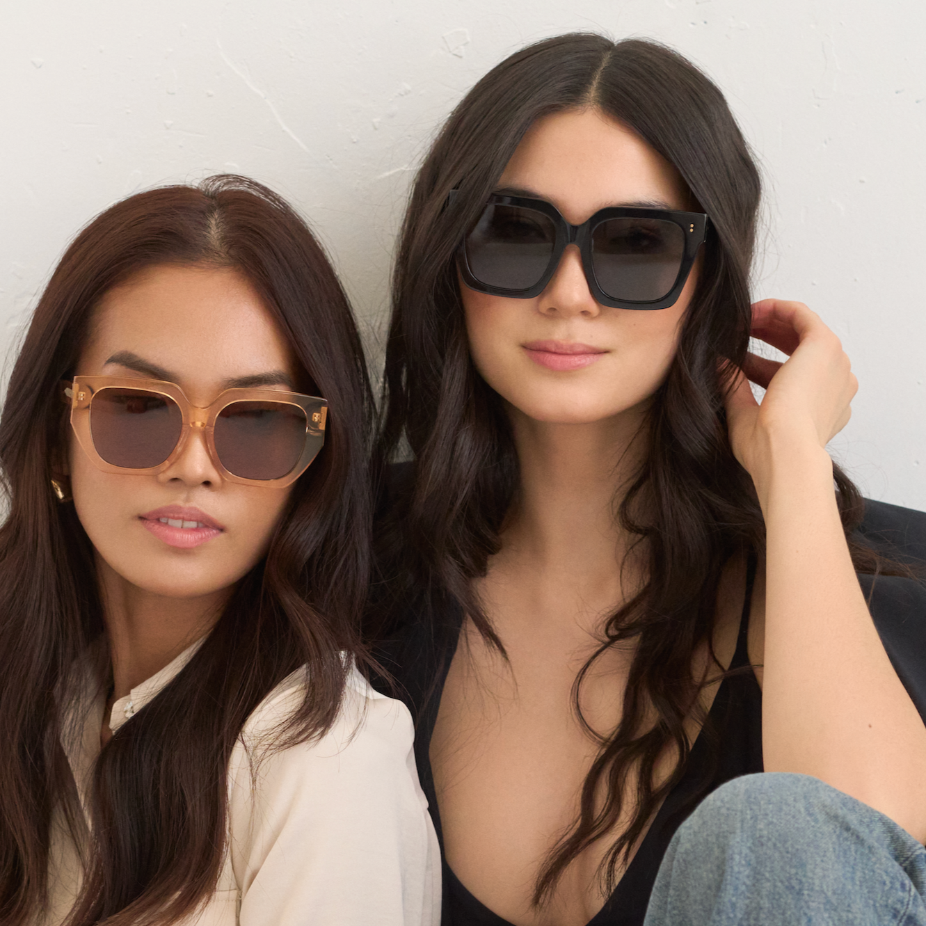 Two women wear KayTran Eyewears Logan - Polished Black sunglasses against a plain white background.