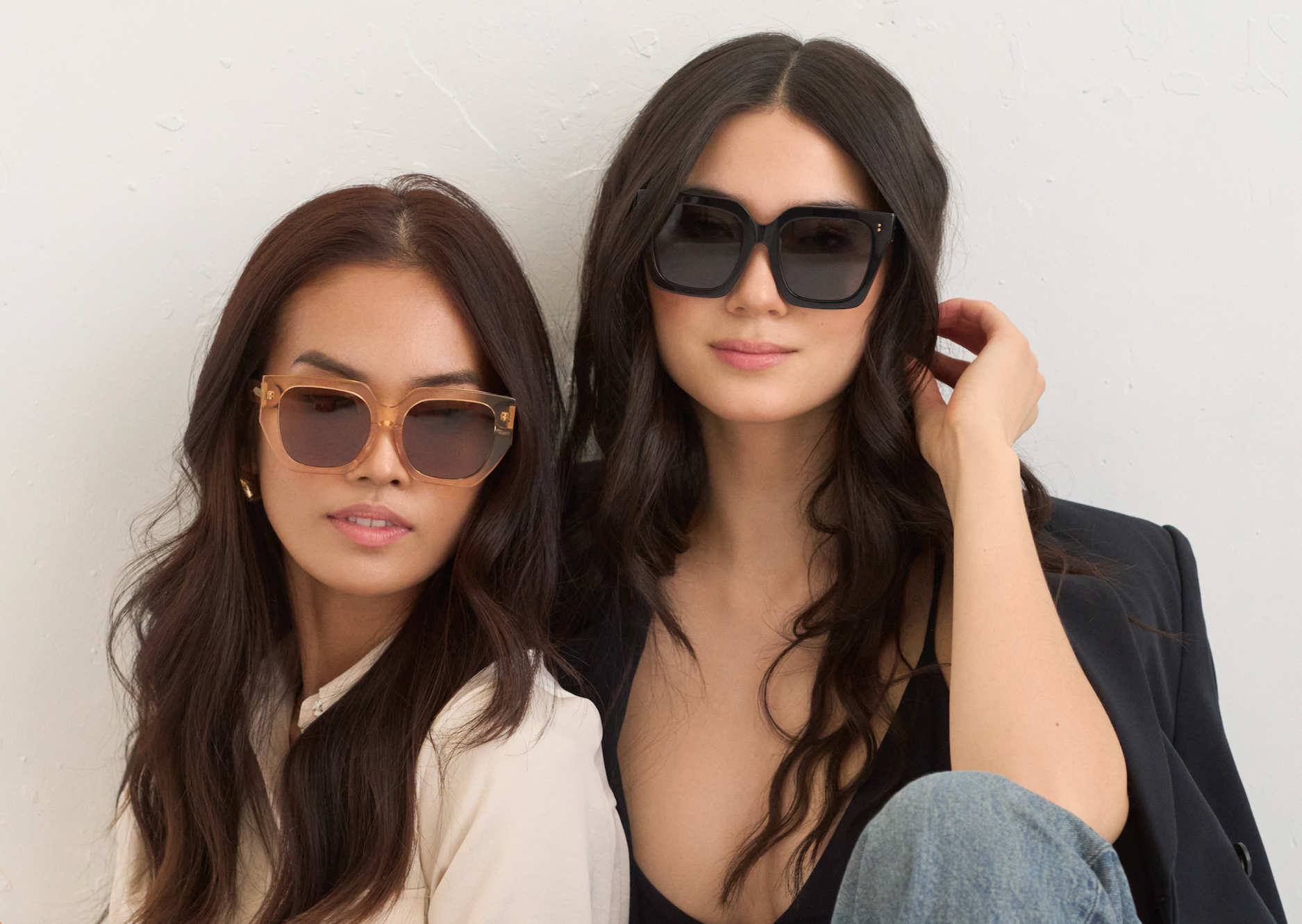 Two women wear KayTran Eyewears Logan - Polished Black sunglasses against a plain white background.