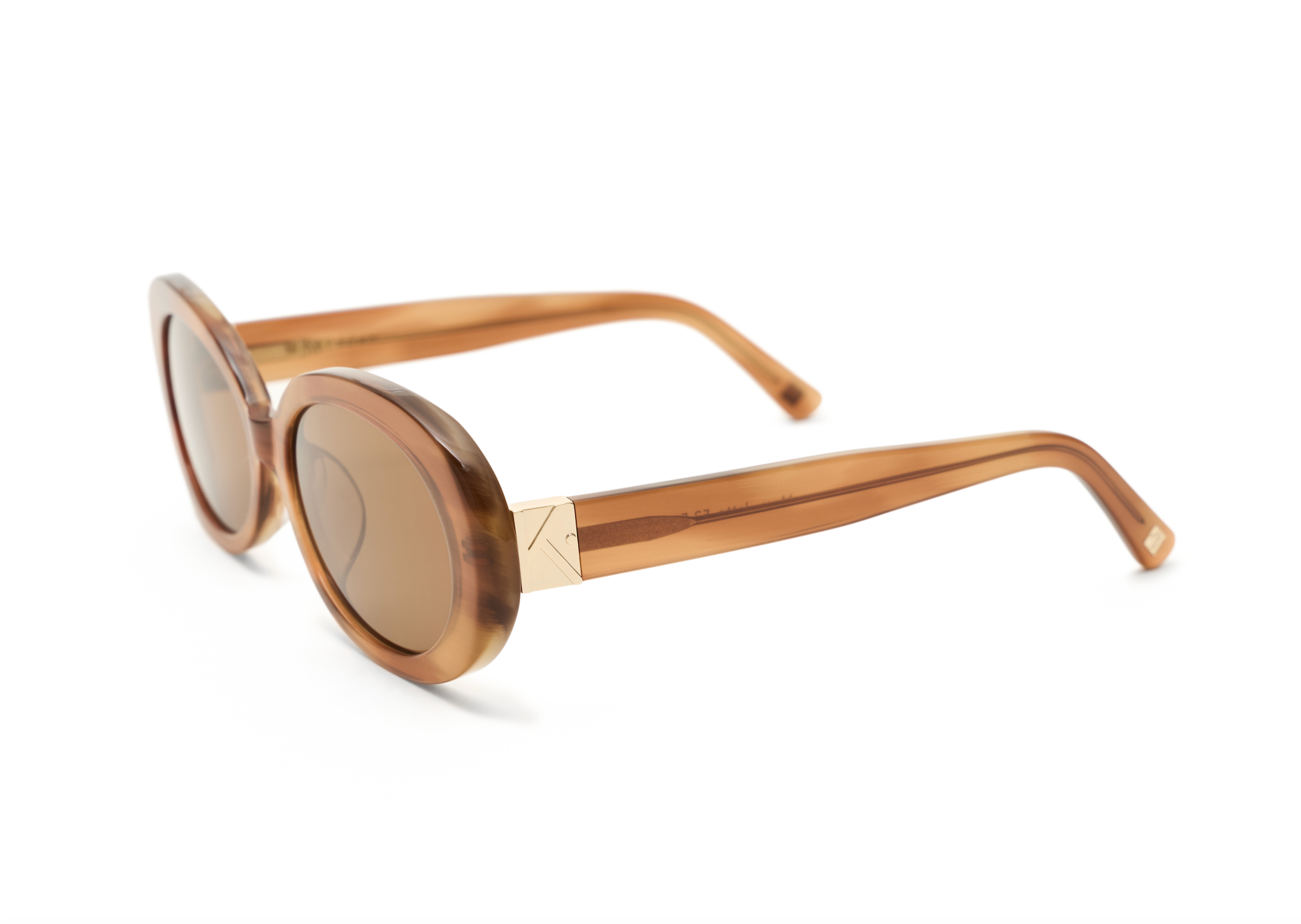 Mara - Latte by KayTran Eyewear: brown oval sunglasses with gold accents, displayed on a white background.