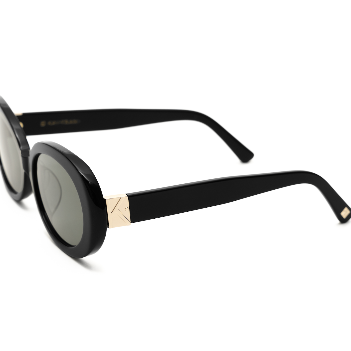 Mara - Polished Black by KayTran Eyewear: stylish round sunglasses with dark lenses and gold temple accents.