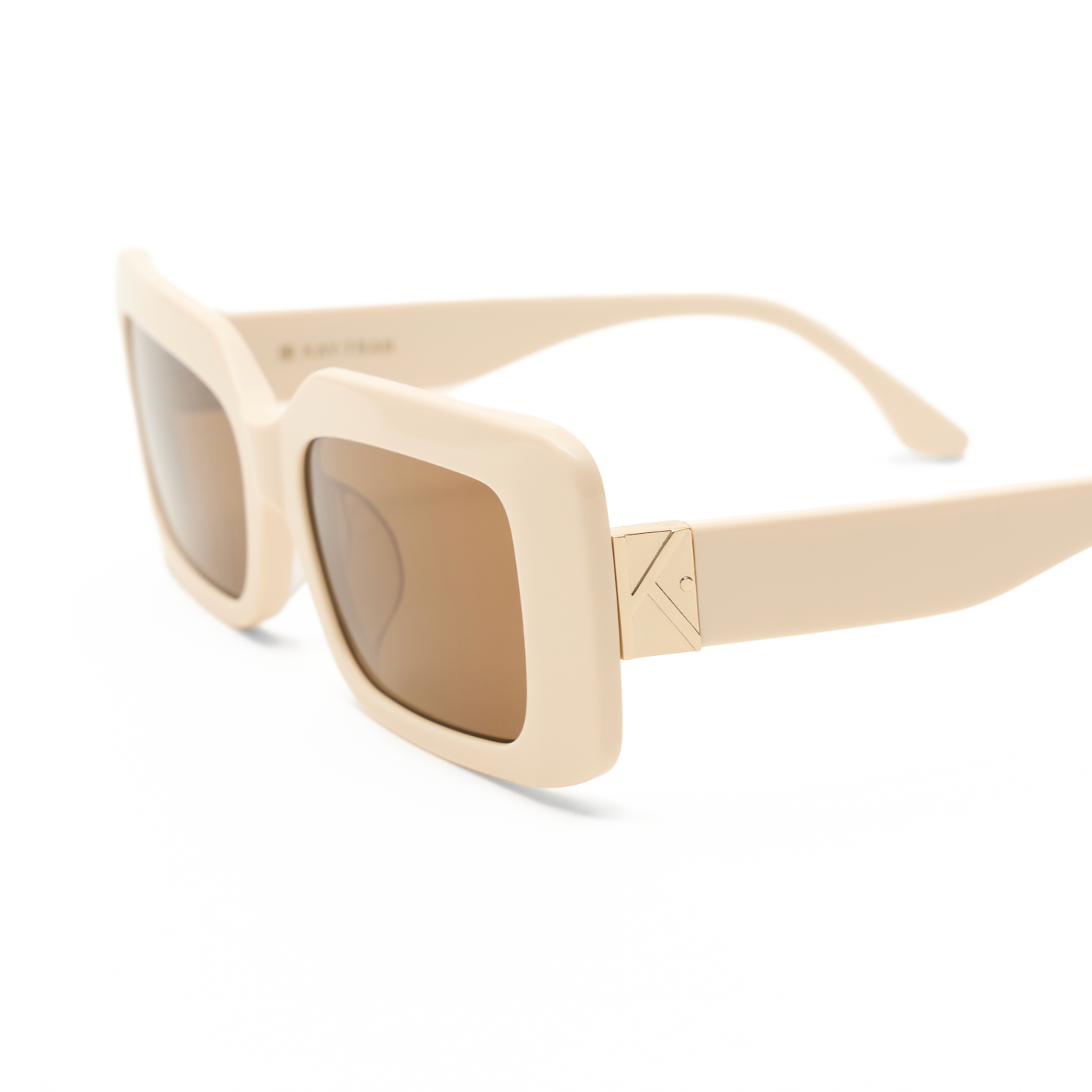 Brooks - Ecru by KayTran Eyewear: cream rectangular sunglasses with brown lenses, gold hinge detail, on white background.
