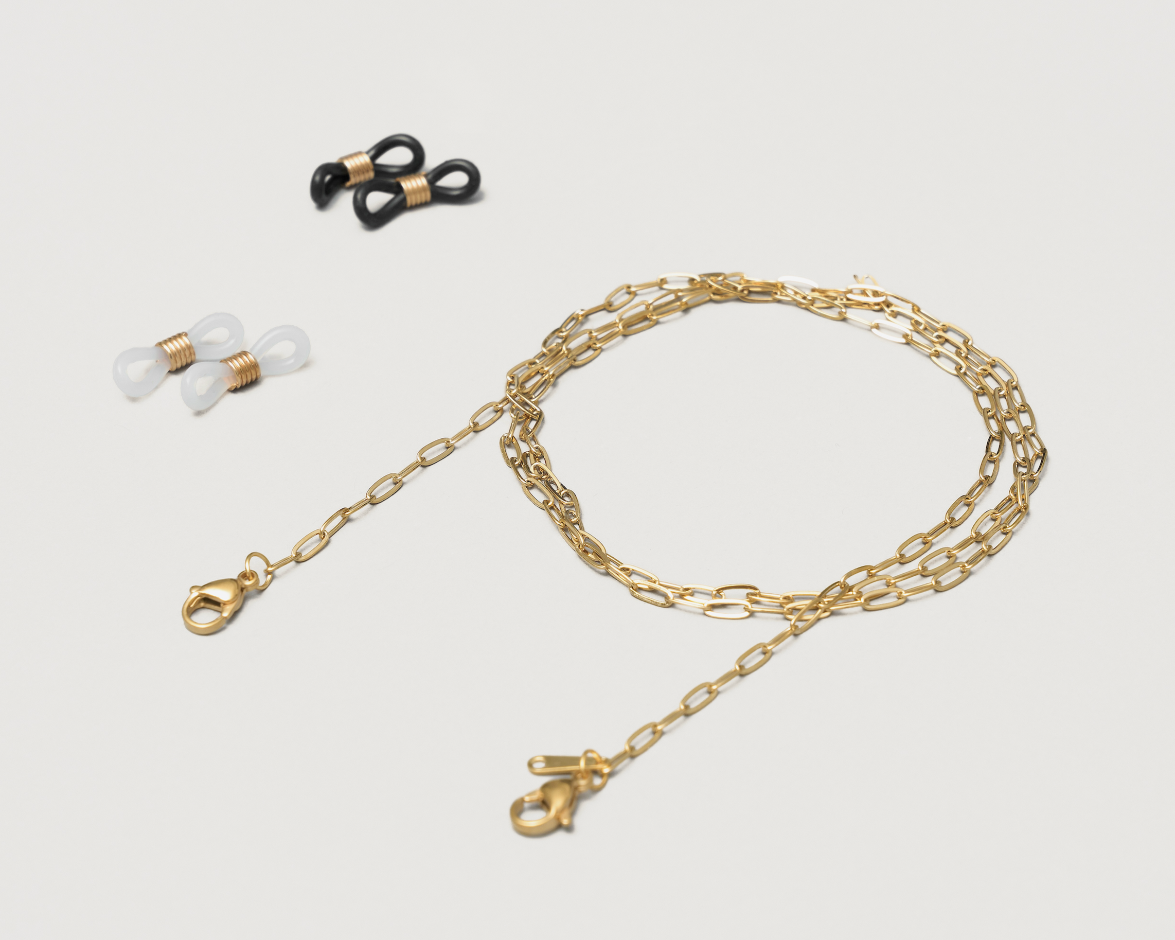 The KayTran Eyewear Chain (KayTran x Aiori) is shown with two pairs of silicone eyeglass holder loops, black and clear.