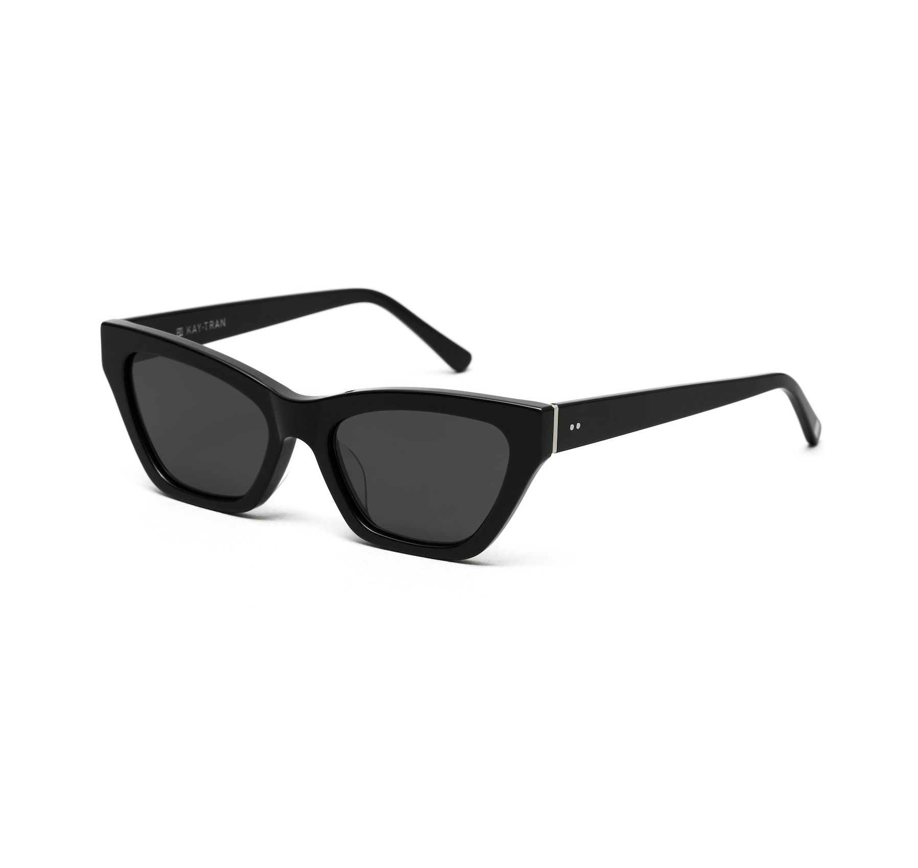 Kai - Polished Black by KayTran Eyewear: black rectangular sunglasses with thick frames, shown angled on white.