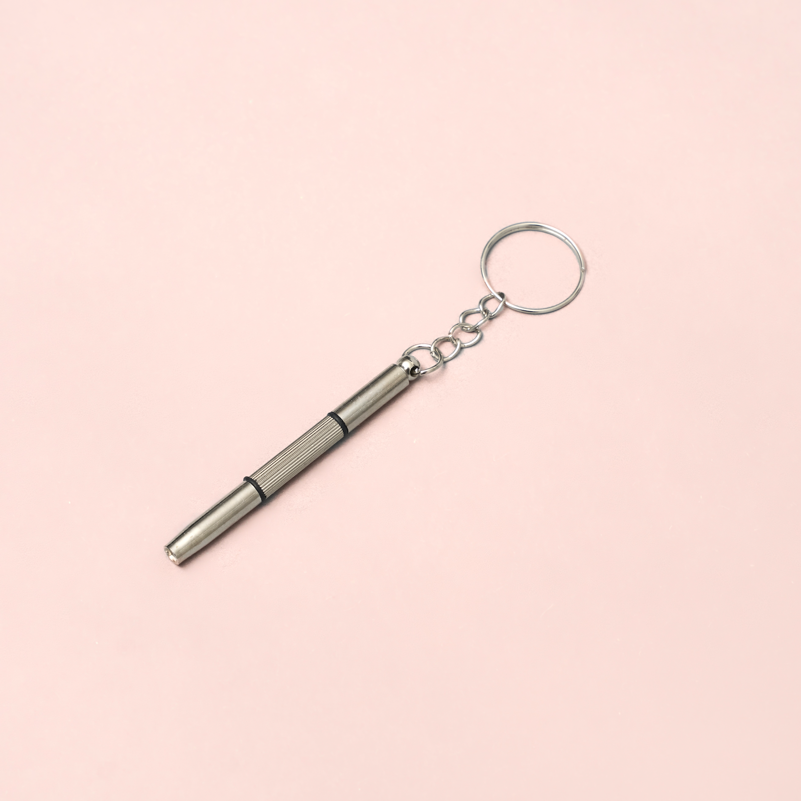 KayTran Eyewear KayTran x Ton Ton Art Tune Up Kit: metal screwdriver keychain with textured grip on pink background.