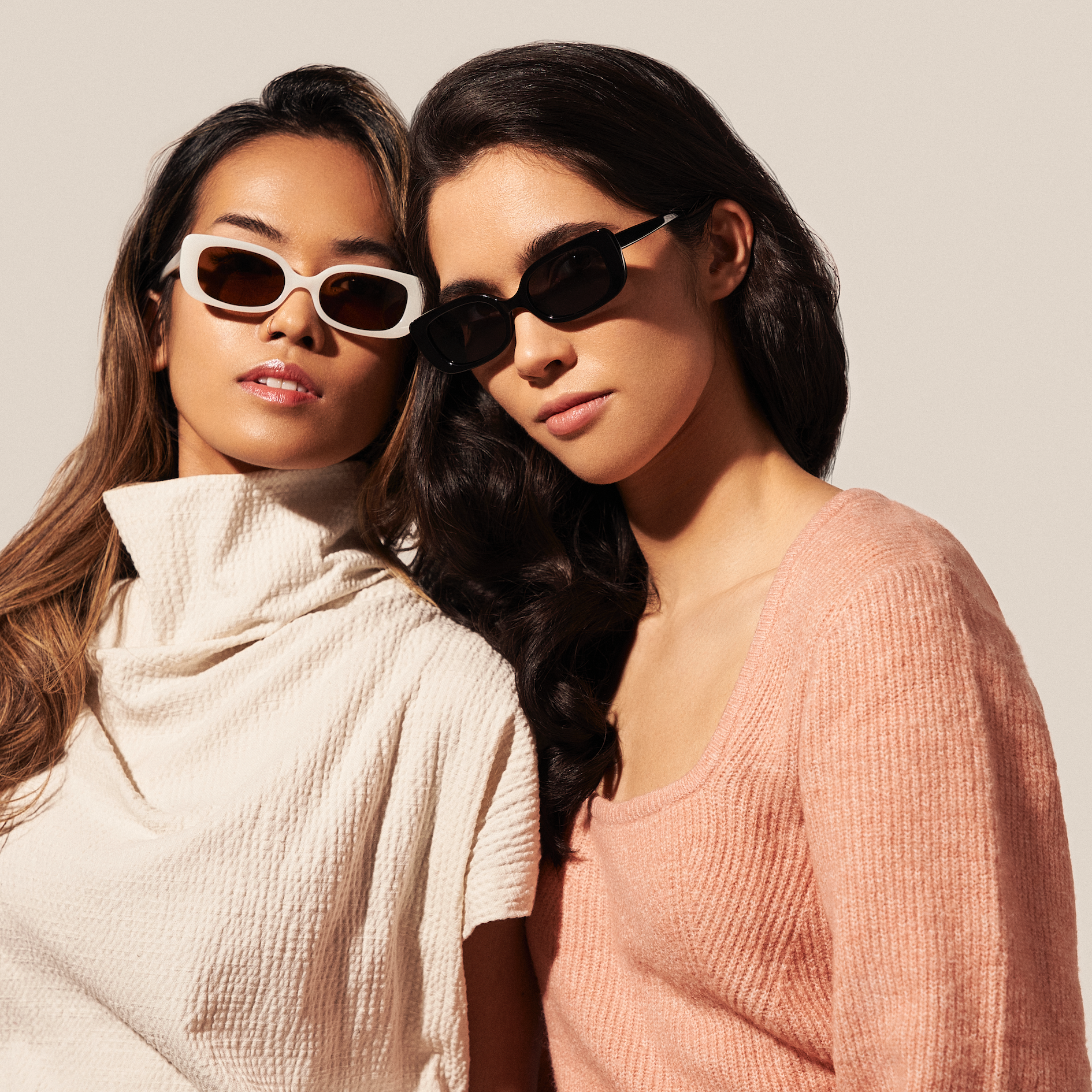Two women wear KayTran Eyewears Billie - Polished Black sunglasses, posing against a plain, light background.