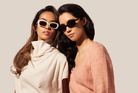 Two women wear KayTran Eyewears Billie - Polished Black sunglasses, posing against a plain, light background.