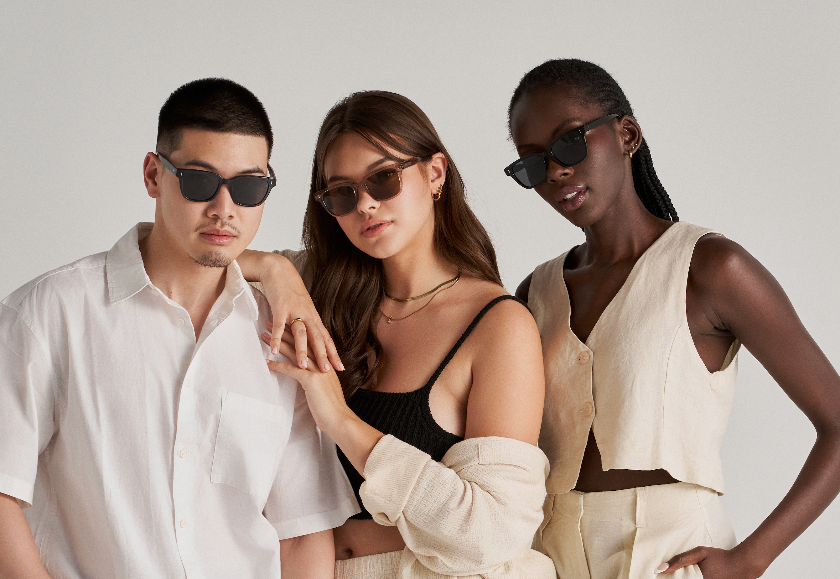 Three people pose in KayTran Eyewear’s Charlie - Polished Black sunglasses against a plain light background.