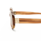 Close-up of Mara - Latte by KayTran Eyewear, brown acetate frames with gold hinge detail on white background.