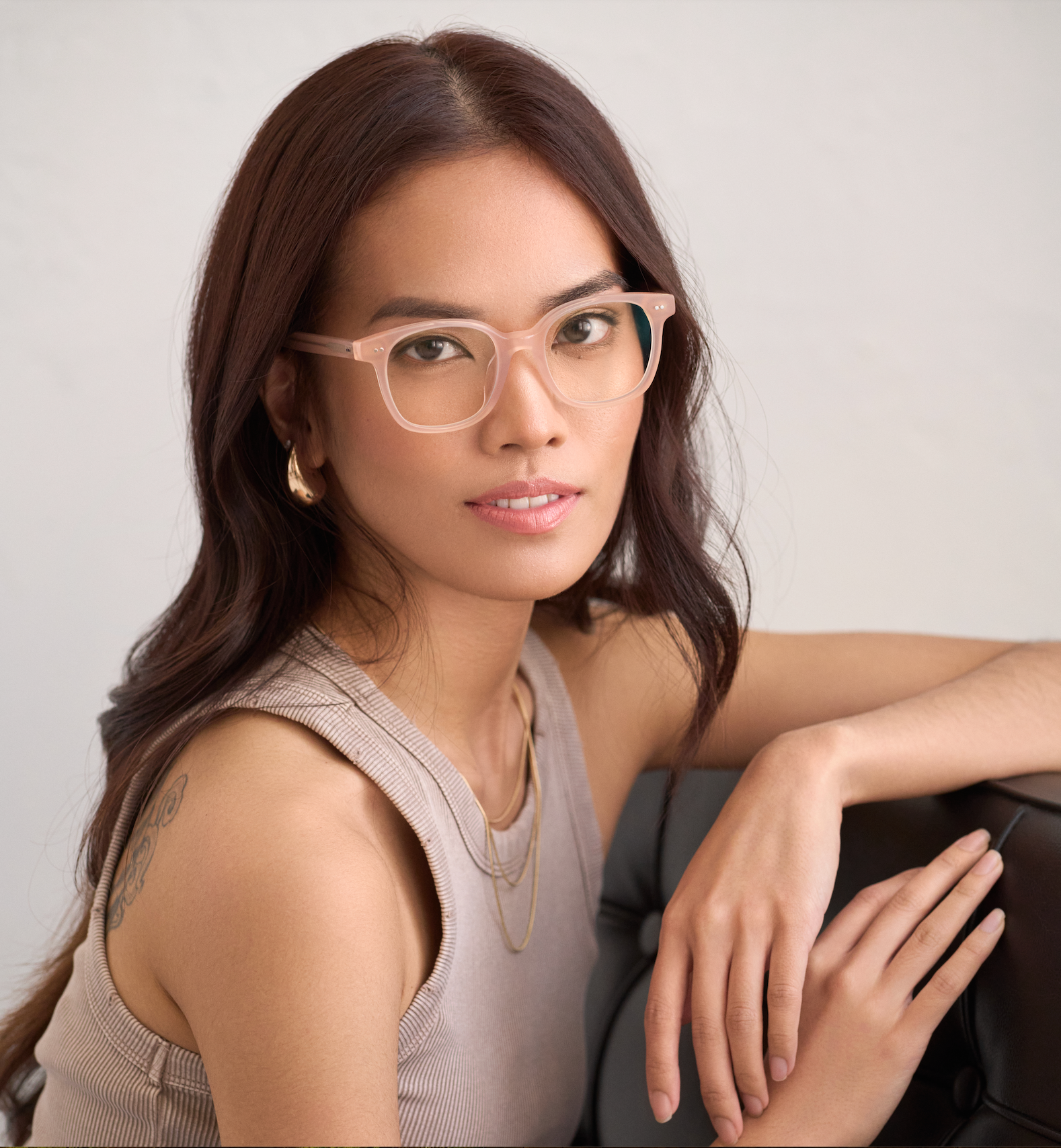 Woman with long brown hair and glasses, wearing KayTran Eyewear Easton in Peach Blush.