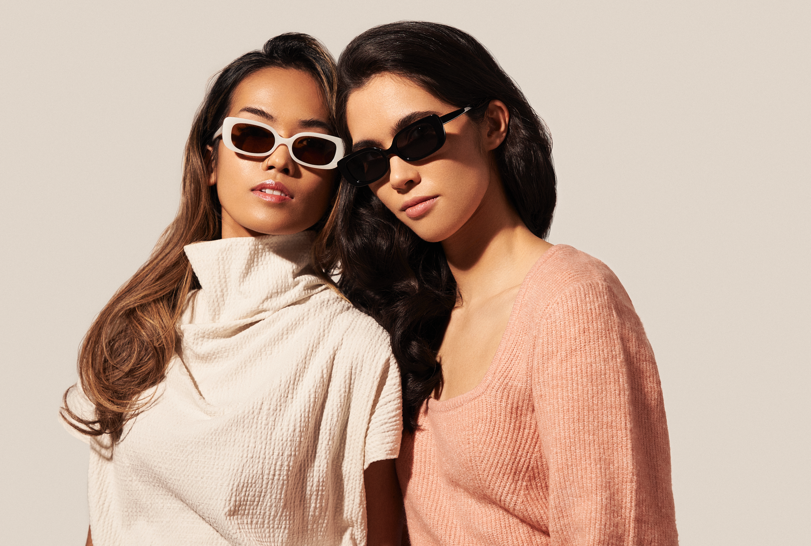 Two women wear KayTran Eyewears Billie - Polished Black sunglasses, posing against a plain, light background.